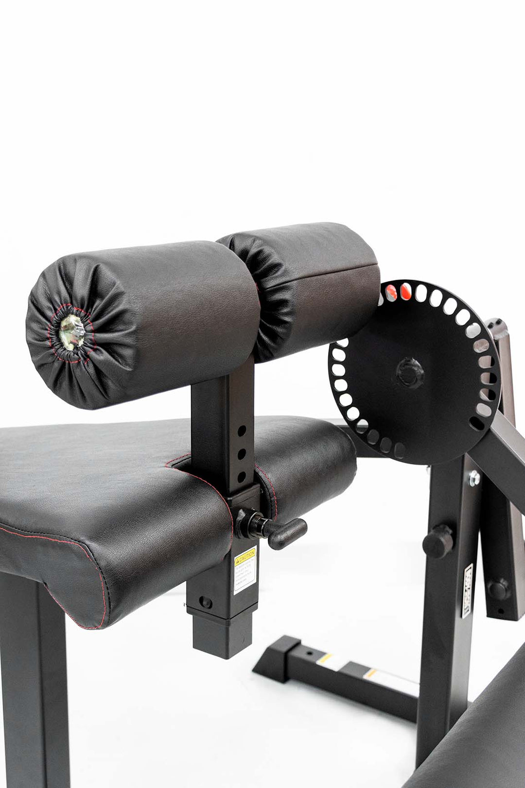 Foam leg holder on leg extension and curl machine