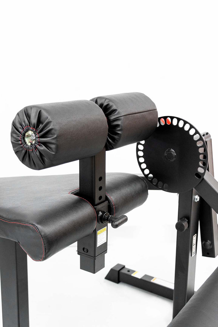 Foam leg holder on leg extension and curl machine