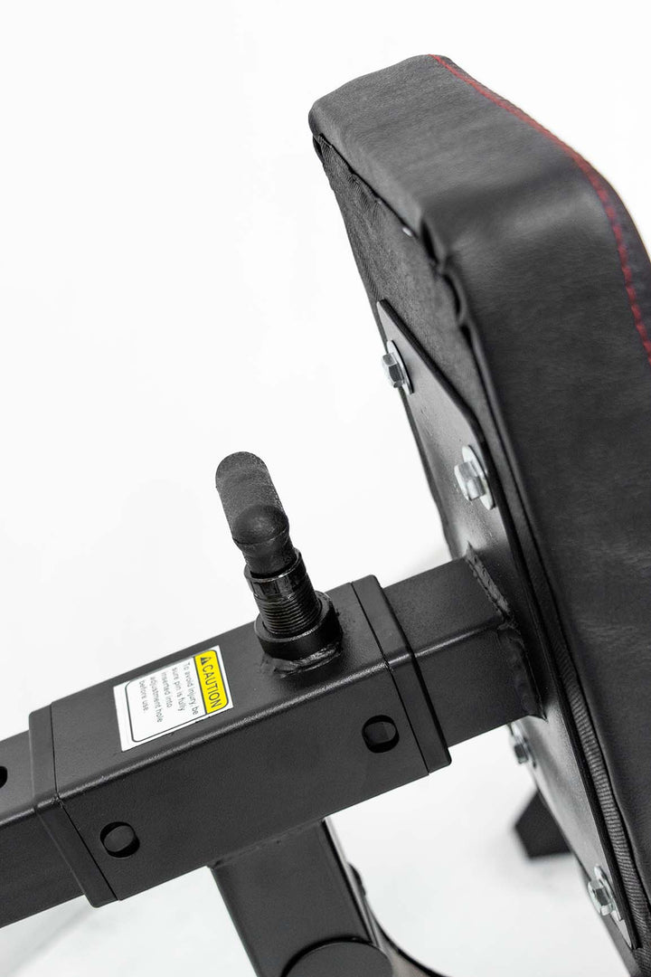 adjustment dial on back pad of exercise machine