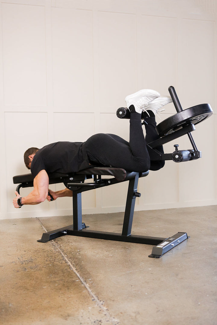 Man doing hamstring curls on prone leg curl machine
